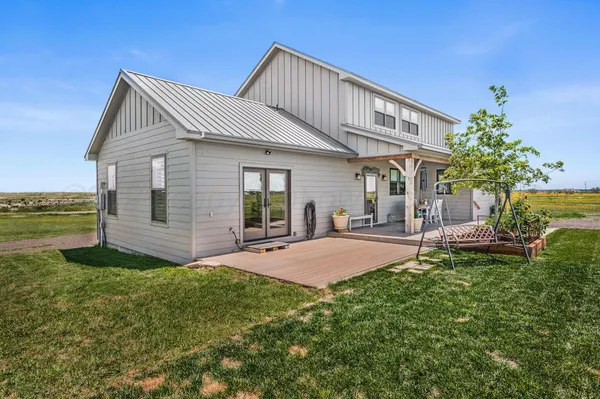 a front view of a house with a yard and porch