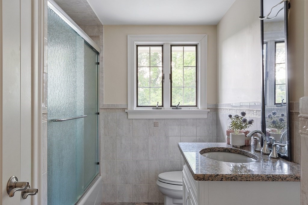 25 Viking Road Saugus, MA 01906 - Photo 13 of 33 a bathroom with a granite countertop sink toilet and mirror