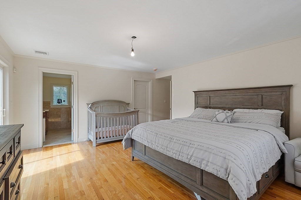 25 Viking Road Saugus, MA 01906 - Photo 18 of 33 a bedroom with a bed and a chandelier