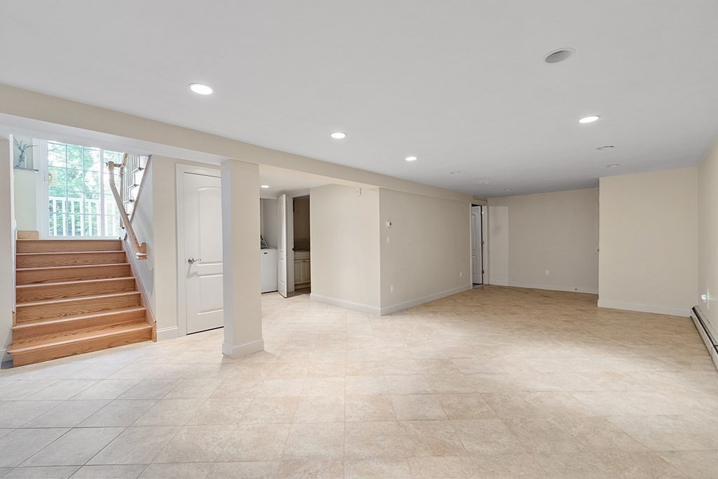 25 Viking Road Saugus, MA 01906 - Photo 19 of 33 a view of an empty room with wooden floor and windows