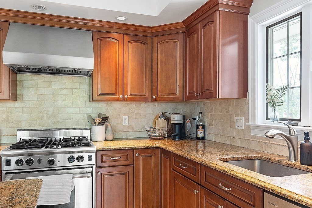 25 Viking Road Saugus, MA 01906 - Photo 8 of 33 a kitchen with stainless steel appliances granite countertop a sink stove and cabinets
