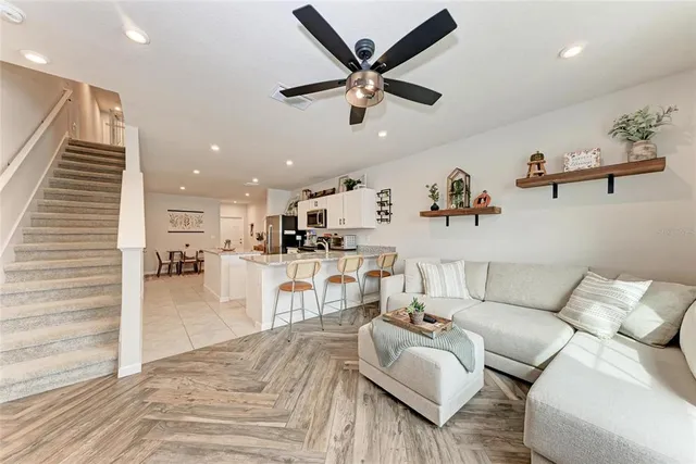 a living room with furniture and kitchen view