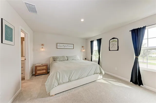 a bedroom with a bed and a large mirror
