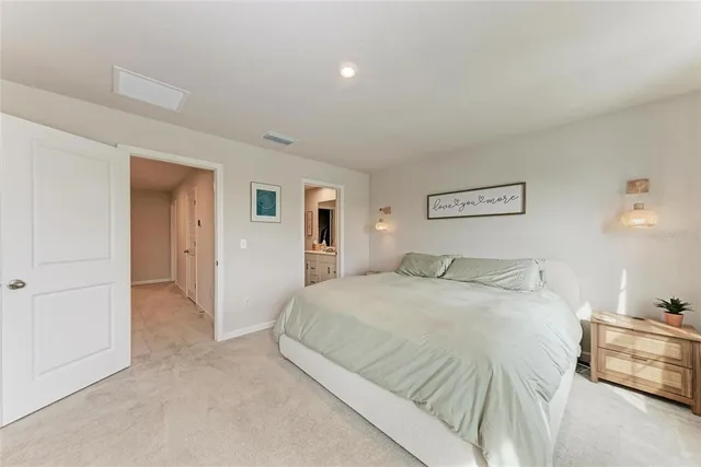 a spacious bedroom with a bed and closet