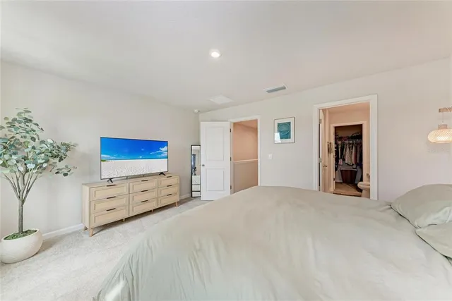 a large white bed in a bedroom