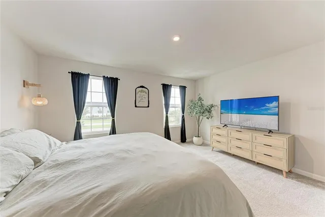 a bedroom with a bed and a dresser