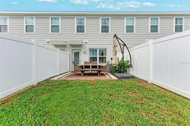 an aerial view of multiple houses with a yard