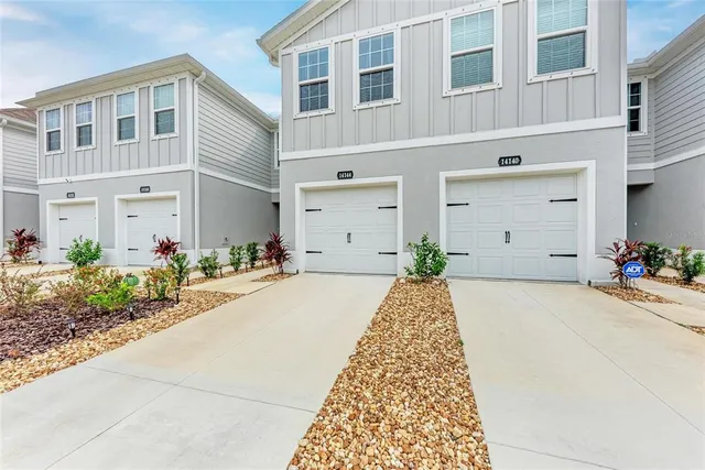 a front view of a building with potted plants