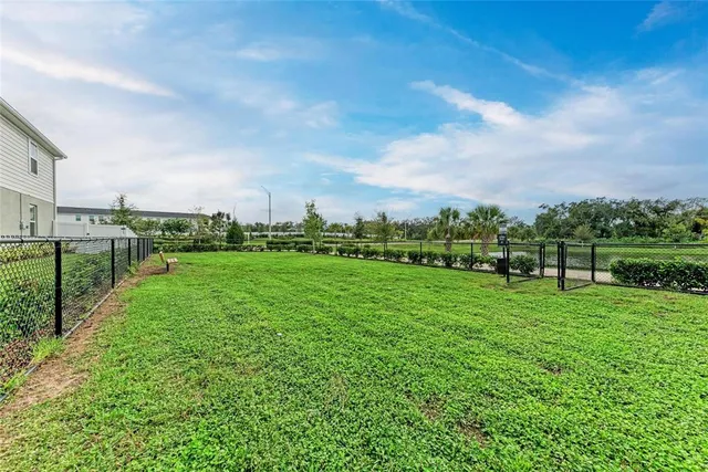 a view of a house with a yard and lake view