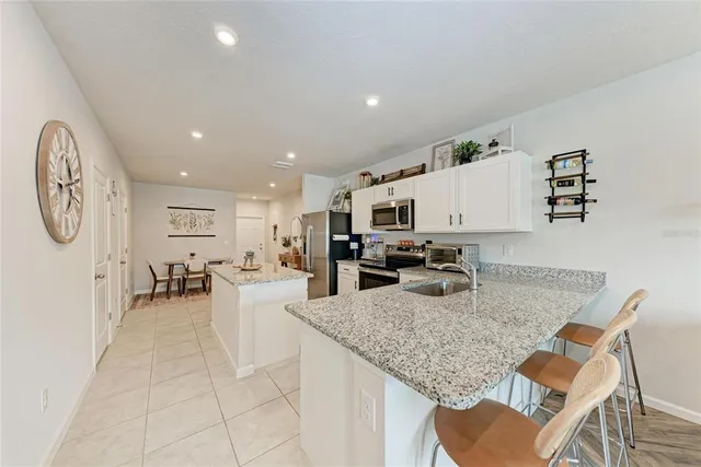 a kitchen with a table chairs and a refrigerator