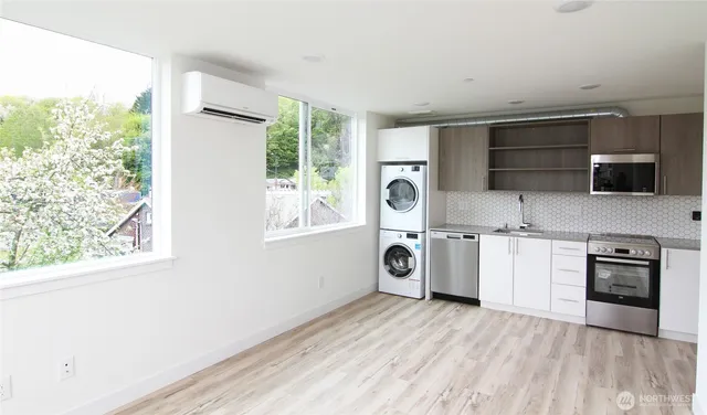 a kitchen with a stove a sink and a microwave