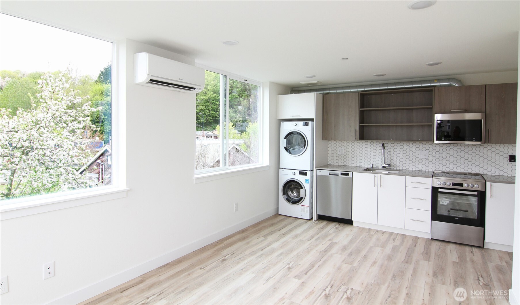 4724 31st Avenue South Seattle, WA 98108 - Photo 11 of 24 a kitchen with a stove a sink and a microwave