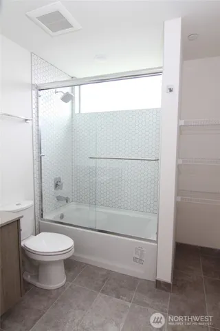 a bathroom with a shower and a toilet
