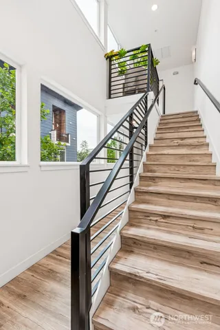 a view of entryway and hall with wooden floor