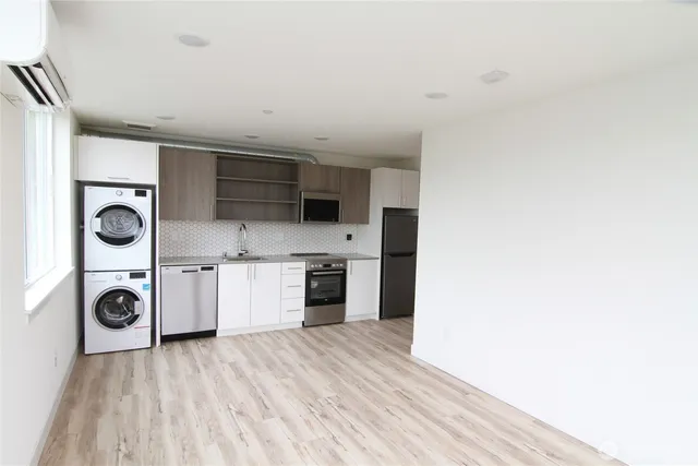 a kitchen with a refrigerator and a stove top oven