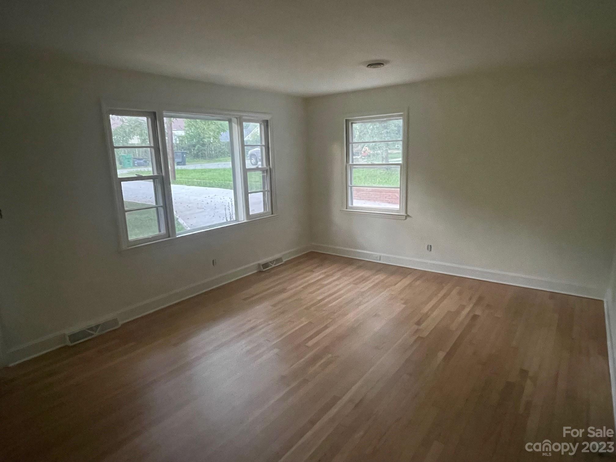 8710 Moody Road Charlotte, NC 28215 - Photo 8 of 14 an empty room with wooden floor and windows