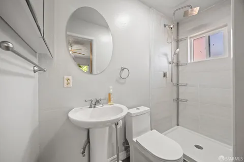 a bathroom with a sink toilet and shower