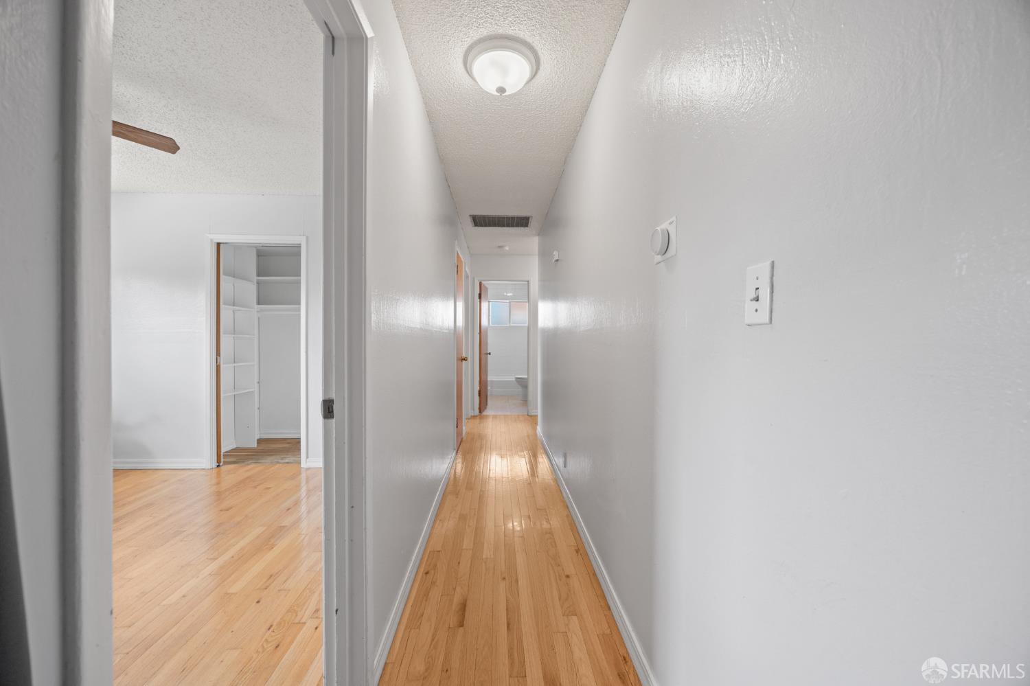 196 Loftus Road Pittsburg, CA 94565 - Photo 17 of 25 a view of a hallway with wooden floor
