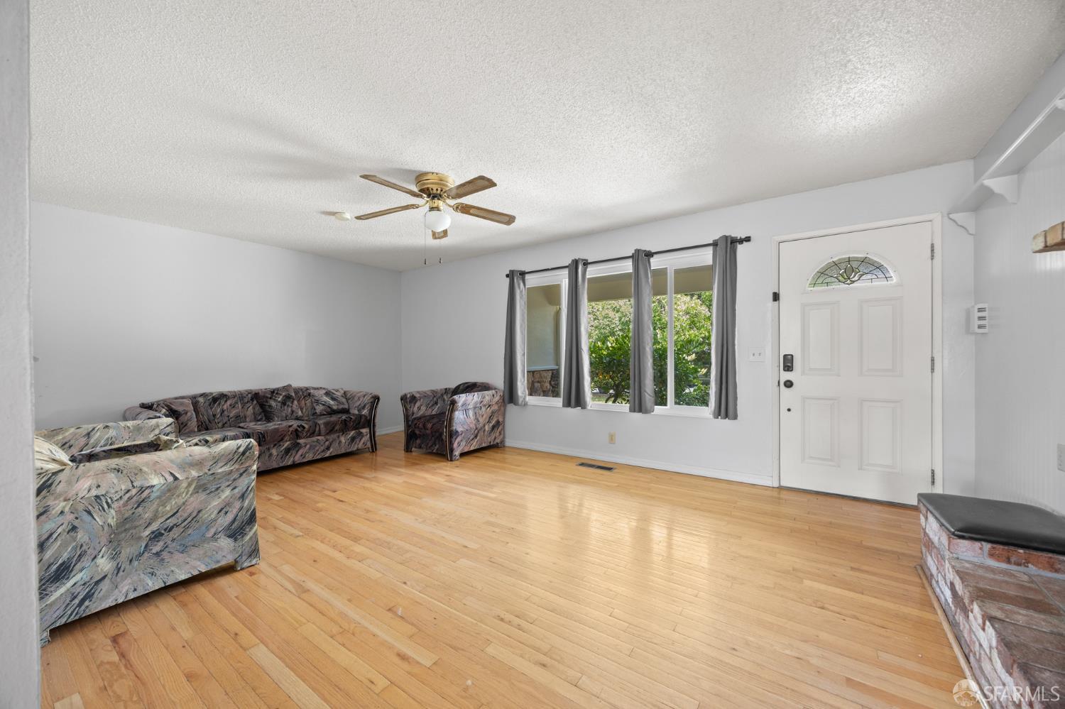 196 Loftus Road Pittsburg, CA 94565 - Photo 5 of 25 a living room with furniture and a large window