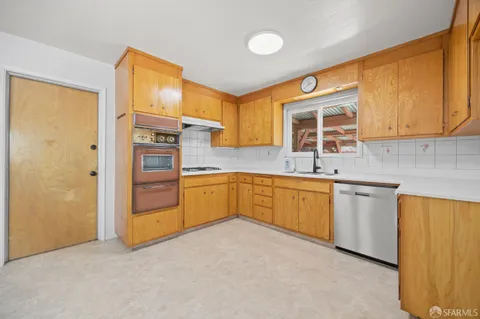 a kitchen with stainless steel appliances granite countertop a sink and cabinets