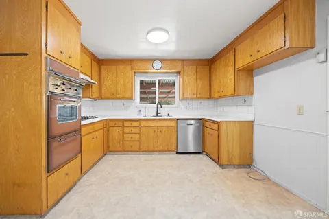 a kitchen with stainless steel appliances granite countertop a sink and cabinets