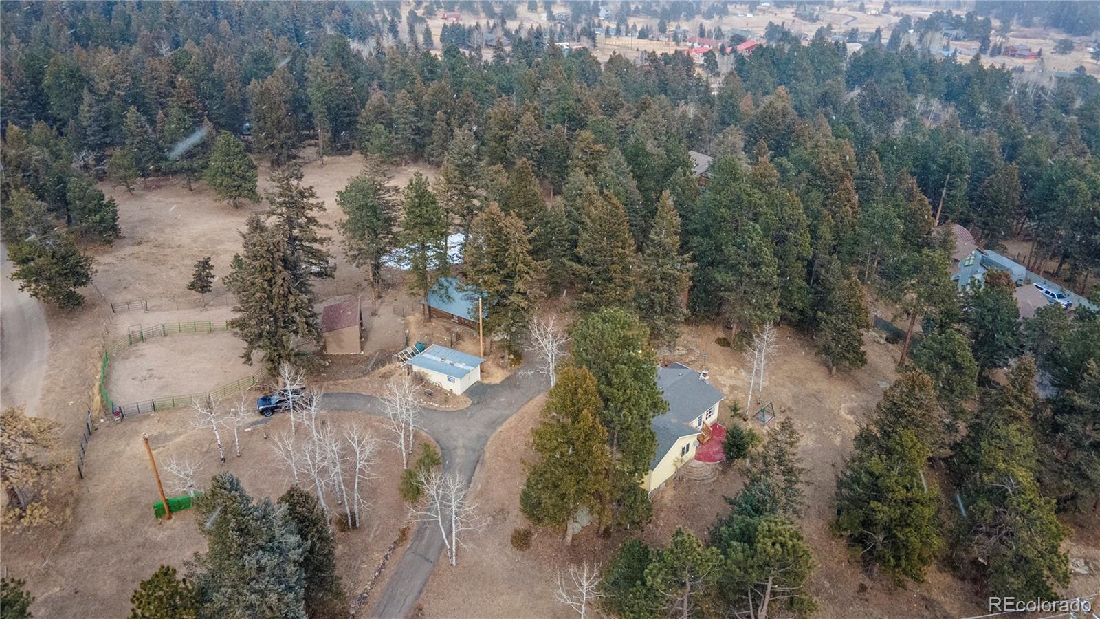 8830 South Blue Creek Road Evergreen, CO 80439 - Photo 1 of 39 an aerial view of residential house with outdoor space