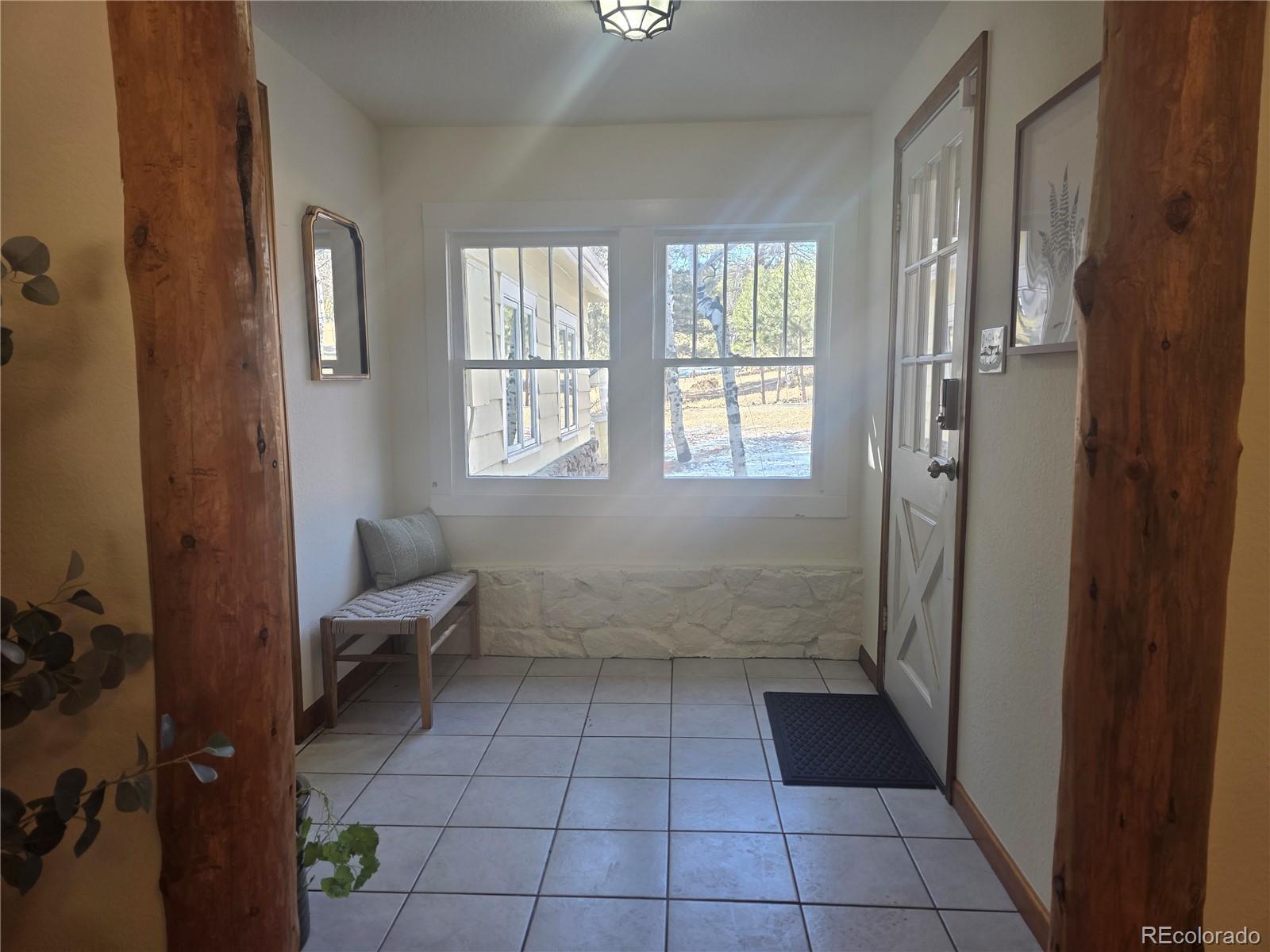 8830 South Blue Creek Road Evergreen, CO 80439 - Photo 15 of 39 a bathroom with a glass door shower and a toilet
