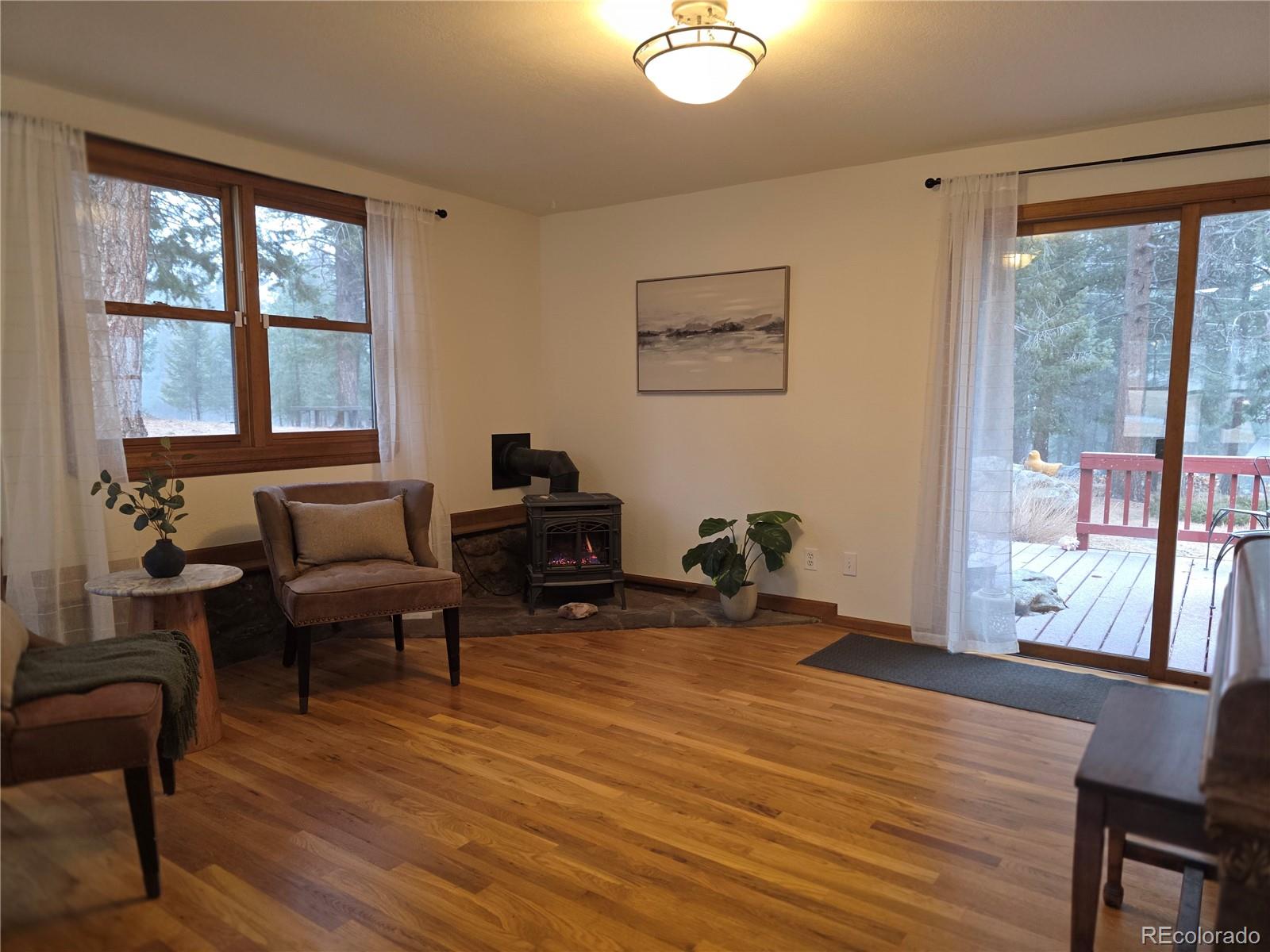 8830 South Blue Creek Road Evergreen, CO 80439 - Photo 16 of 39 a living room with furniture and a large window