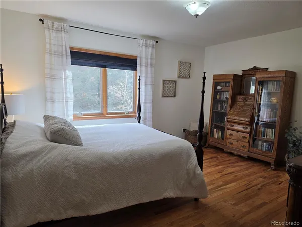 a bedroom with a bed and a table