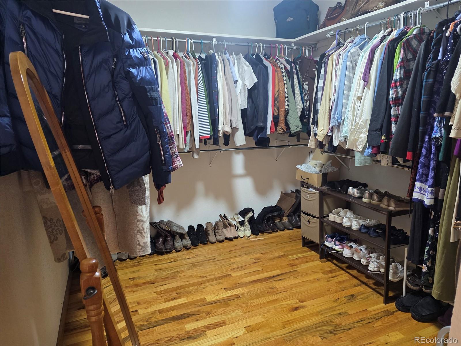 8830 South Blue Creek Road Evergreen, CO 80439 - Photo 26 of 39 a view of walk in closet with clothes and shoes