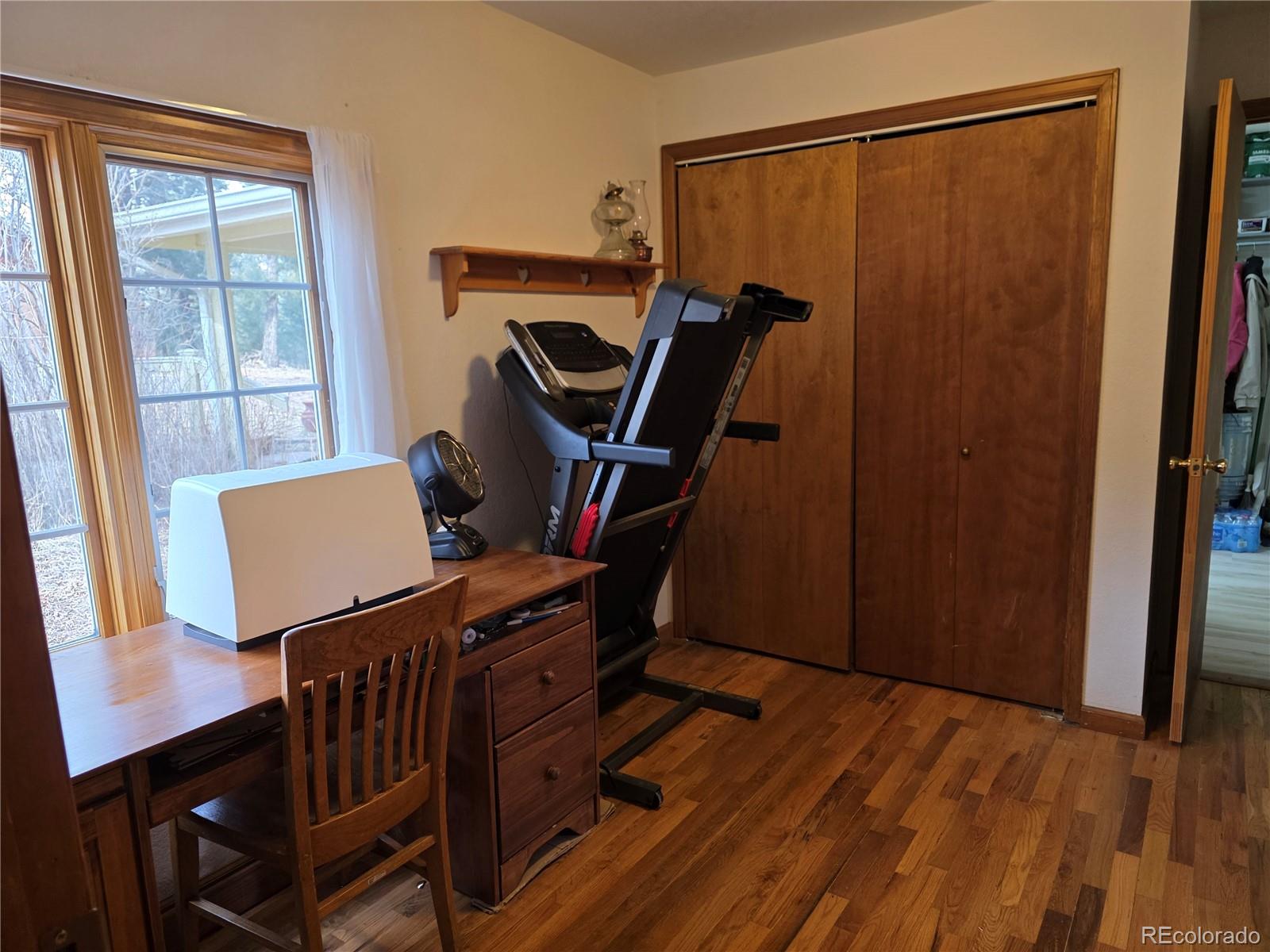 8830 South Blue Creek Road Evergreen, CO 80439 - Photo 29 of 39 a view of a workspace with furniture and a window