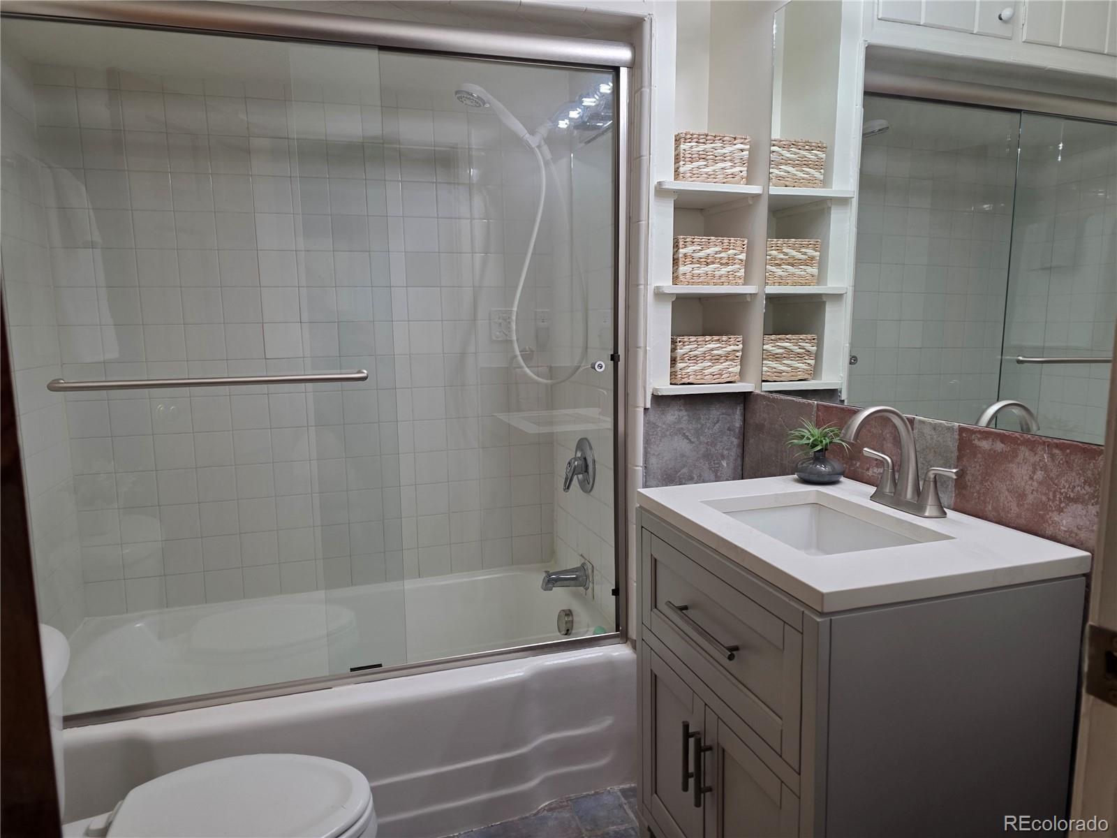 8830 South Blue Creek Road Evergreen, CO 80439 - Photo 30 of 39 a bathroom with a sink toilet and shower