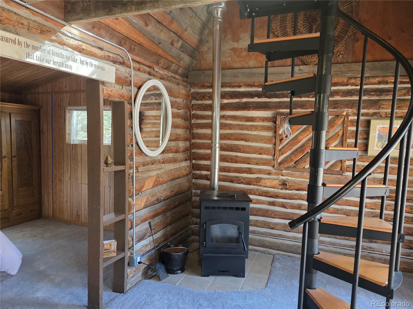 8830 South Blue Creek Road Evergreen, CO 80439 - Photo 32 of 39 a view of staircase with wooden floor and a window