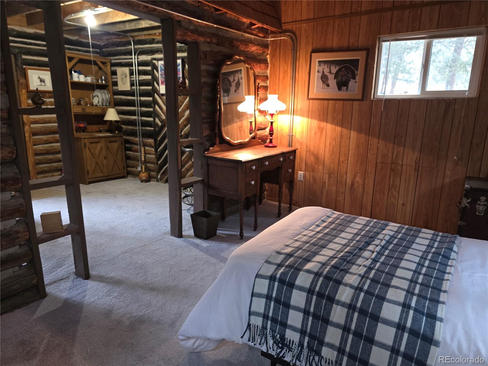 8830 South Blue Creek Road Evergreen, CO 80439 - Photo 35 of 39 a bedroom with a bed and walk in closet