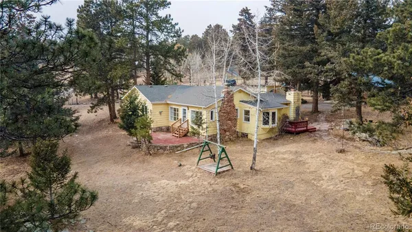 a view of a house with a yard and sitting area
