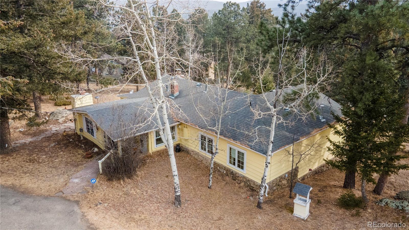 8830 South Blue Creek Road Evergreen, CO 80439 - Photo 5 of 39 an aerial view of a house with large trees