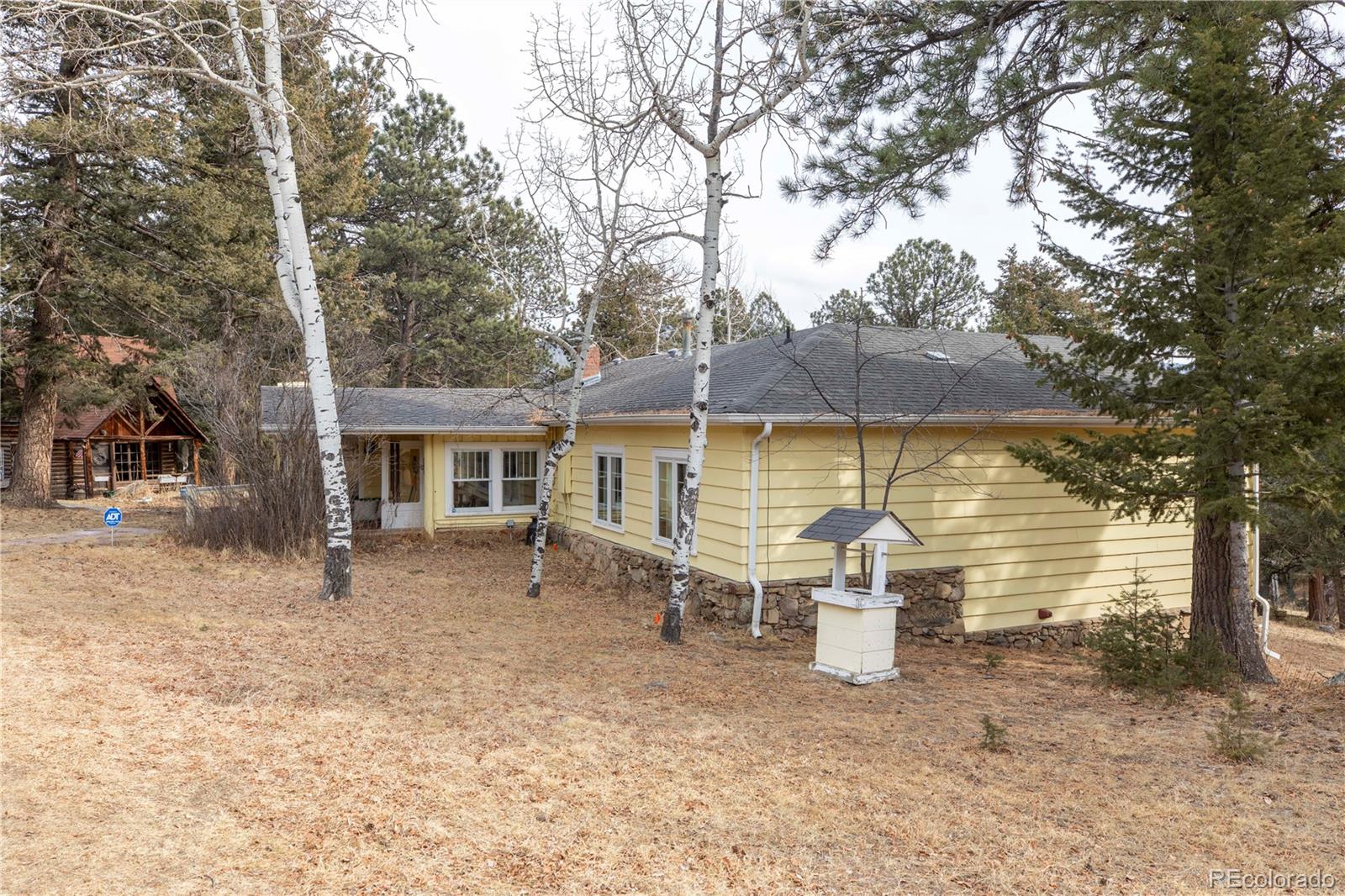 8830 South Blue Creek Road Evergreen, CO 80439 - Photo 7 of 39 a view of a house with backyard porch and sitting area