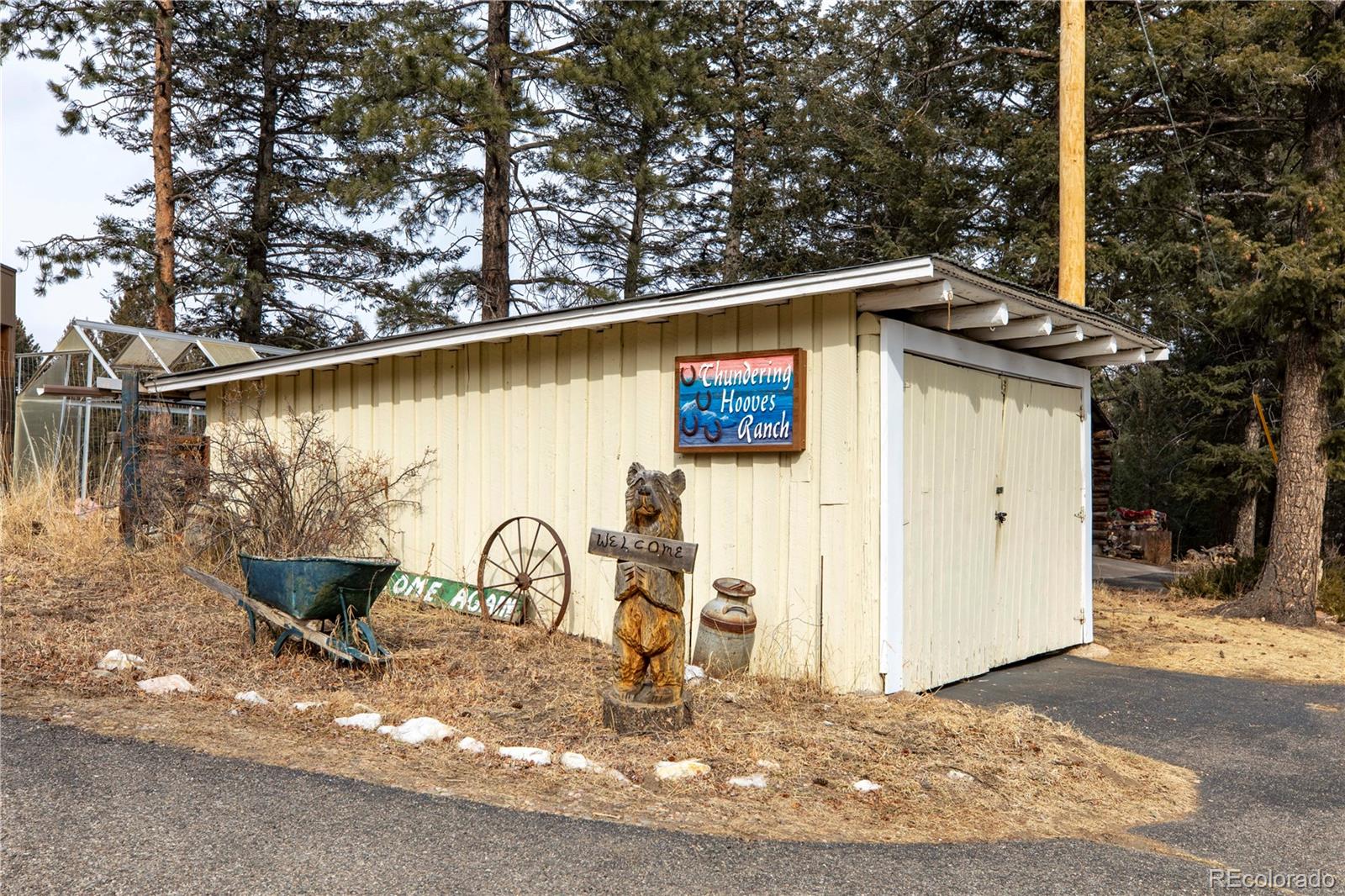 8830 South Blue Creek Road Evergreen, CO 80439 - Photo 9 of 39 a front view of a house with garden