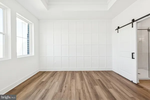 a view of a room with wooden floor and white walls