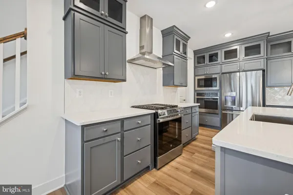 a kitchen with a sink and stainless steel appliances