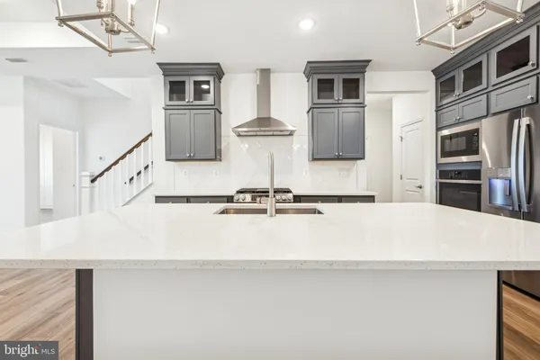 a view of living room with furniture and stainless steel appliances