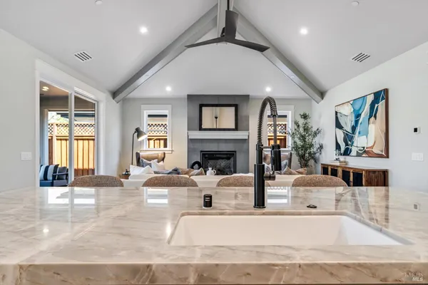 a living room with fireplace furniture and a large window