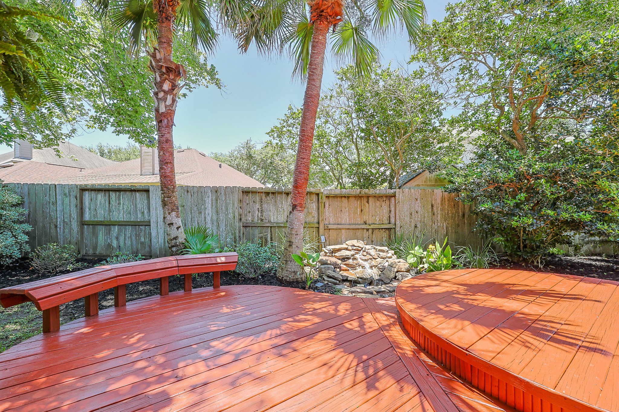 10306 Rudolph Court Missouri City, TX 77459 - Photo 25 of 34 Your own private sanctuary featuring an expansive multi-level wood deck designed for ultimate outdoor relaxation and entertaining.