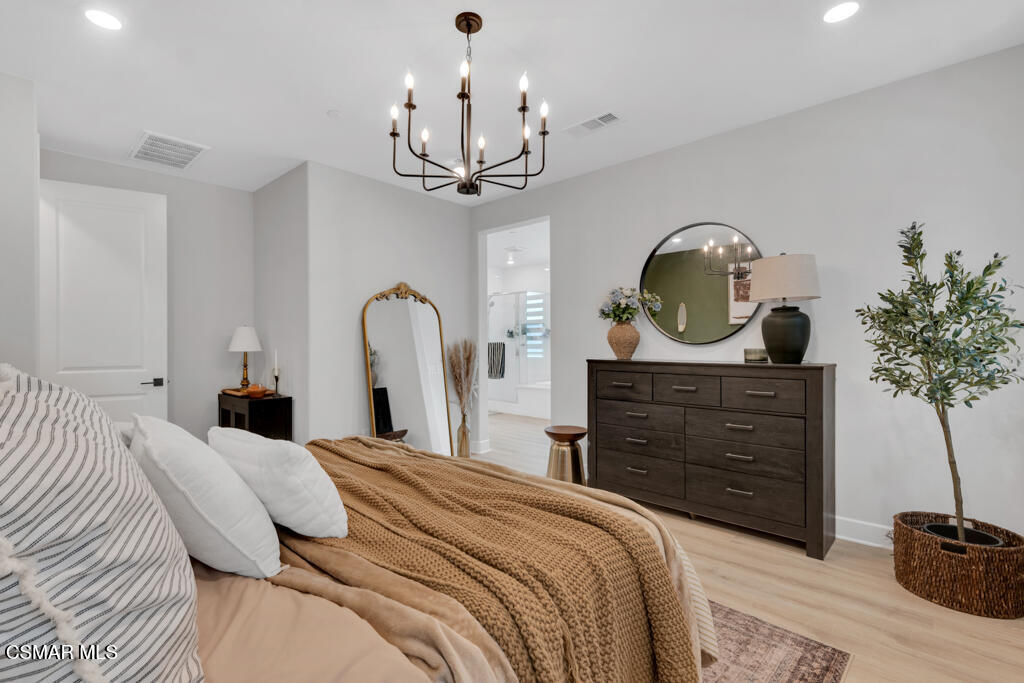 3028 Harrison Lane Simi Valley, CA 93065 - Photo 26 of 47 a bedroom with a bed and a chandelier