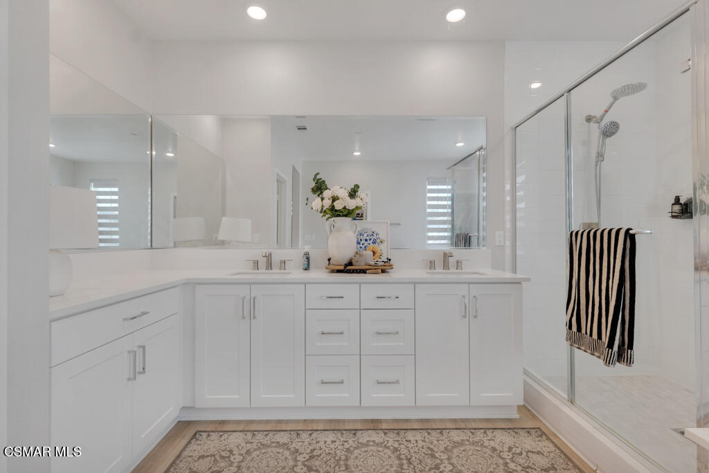 3028 Harrison Lane Simi Valley, CA 93065 - Photo 29 of 47 a bathroom with a sink a mirror and a shower