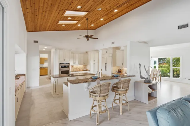 a kitchen with white cabinets and appliances
