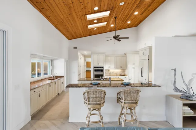 a kitchen with granite countertop a stove and a sink