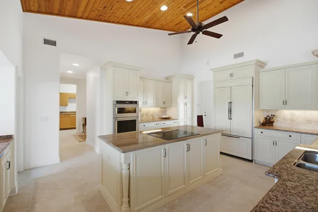 a kitchen with a sink and a large window
