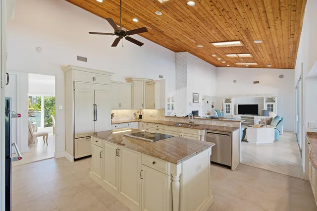 a bathroom with a granite countertop sink toilet a mirror and shower
