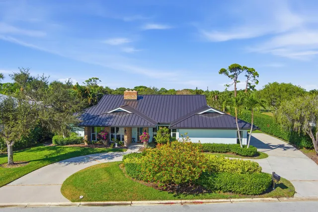a front view of a house with plants